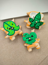 3D silicone earbud cases shaped like a woodland sprite with cream and orange fall stripes.
