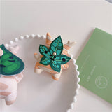 3D silicone earbud cases shaped like a woodland sprite with cream and orange fall stripes