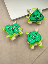 3D silicone earbud cases shaped like a woodland sprite with cream and green spring stripes.