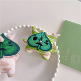 3D silicone earbud cases shaped like a woodland sprite with cream and green spring stripes.