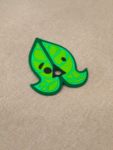Six interchangeable green silicone leaf masks for a customizable earbud case, featuring heart, star, butterfly, and whisker shapes.