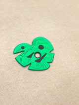 Six interchangeable green silicone leaf masks for a customizable earbud case, featuring heart, star, butterfly, and whisker shapes.