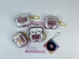 Clear earbud case filled with pink liquid glitter, attached to a gold cat-shaped clip and a miniature vinyl record keychain.