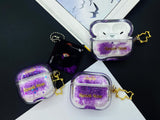Clear earbud case filled with royal purple liquid glitter, attached to a gold cat-shaped clip and a miniature vinyl record keychain.
