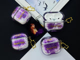 Clear earbud case filled with royal purple liquid glitter, attached to a gold cat-shaped clip and a miniature vinyl record keychain.