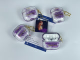 Clear earbud case filled with royal purple liquid glitter, attached to a gold cat-shaped clip and a miniature vinyl record keychain.