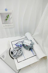 3D grey silicone earbud case shaped like a classic sci-fi spaceship freighter with detailed mechanical paneling.