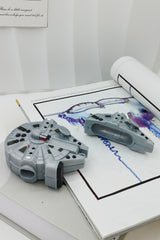 3D grey silicone earbud case shaped like a classic sci-fi spaceship freighter with detailed mechanical paneling.