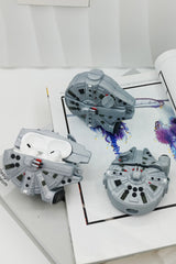 3D grey silicone earbud case shaped like a classic sci-fi spaceship freighter with detailed mechanical paneling.