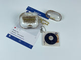 Clear earbud case filled with radiant gold liquid glitter, attached to a gold cat-shaped clip and a miniature vinyl record keychain.