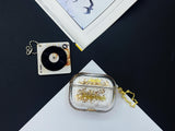 Clear earbud case filled with radiant gold liquid glitter, attached to a gold cat-shaped clip and a miniature vinyl record keychain.