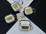 Clear earbud case filled with radiant gold liquid glitter, attached to a gold cat-shaped clip and a miniature vinyl record keychain.