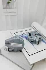 3D grey silicone earbud case shaped like a classic sci-fi spaceship freighter with detailed mechanical paneling.