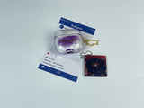 Clear earbud case filled with holographic lavender and blue liquid glitter, attached to a gold cat-shaped clip and a miniature vinyl record keychain.