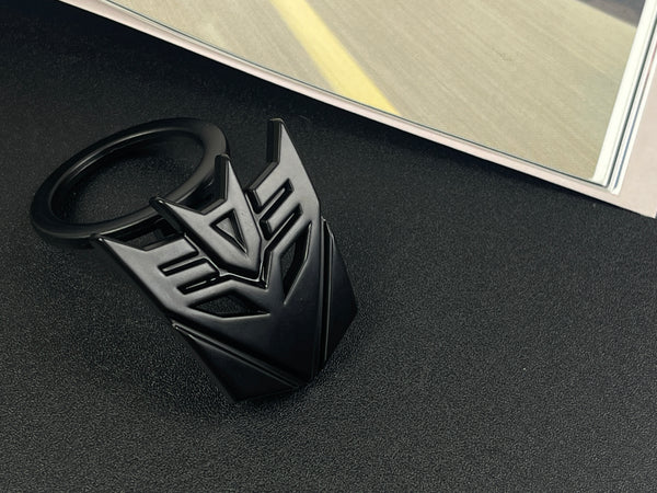 Aggressive mecha-seeker dark metal push start button cover for car interior.