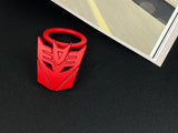 Aggressive mecha-seeker dark metal push start button cover for car interior.