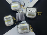 Clear earbud case filled with silver-grey liquid glitter, attached to a gold cat-shaped clip and a miniature vinyl record keychain.