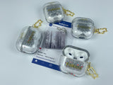 Clear earbud case filled with silver-grey liquid glitter, attached to a gold cat-shaped clip and a miniature vinyl record keychain.