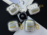Clear earbud case filled with silver liquid glitter and tiny red stars, attached to a gold cat-shaped clip and a miniature vinyl record keychain.