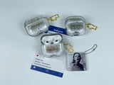 Clear earbud case filled with silver liquid glitter and tiny red stars, attached to a gold cat-shaped clip and a miniature vinyl record keychain.